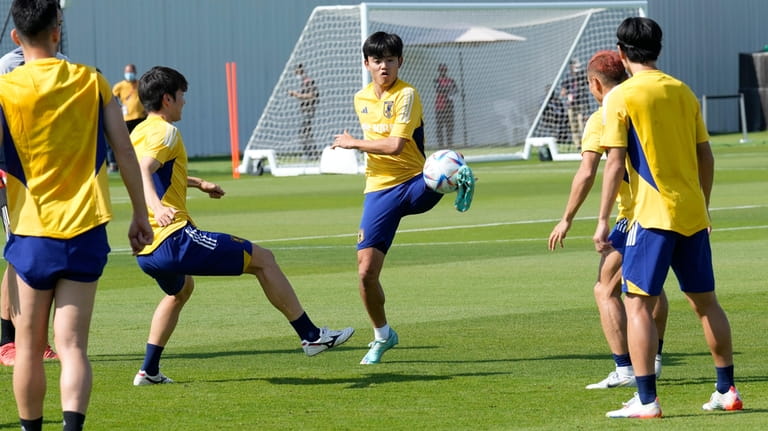 Players warm up during a training session of Japan national...