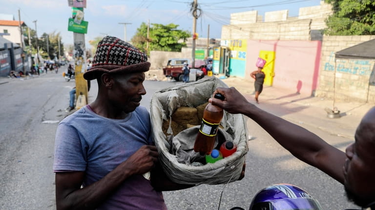 A customer purchases a beverage from a street vendor in...