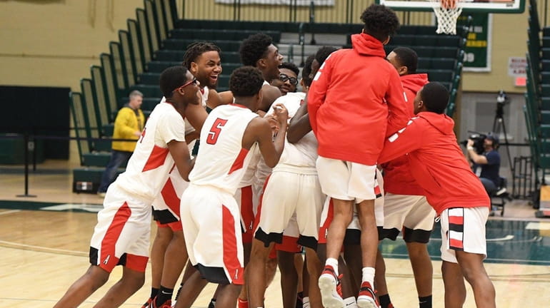 Amityville players celebrate their 83-66 win against Westhampton Beach during...