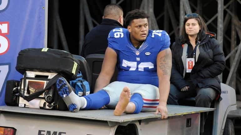 New York Giants offensive tackle Ereck Flowers is carted off...