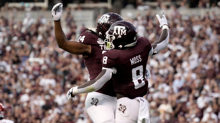 Texas A&M running back Le'Veon Moss (8) and teammate Earnest...