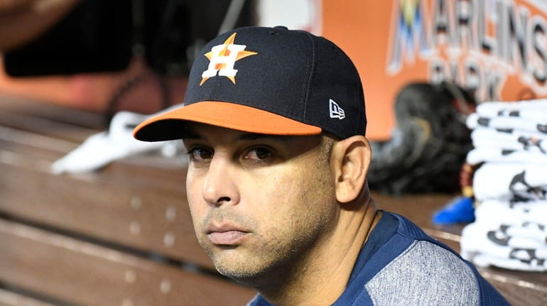 Bench coach Alex Cora of the Houston Astros sits in...