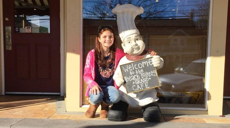 Kidsday reporter Chloe Sword sits outside Beach Bakery Grand Cafe...