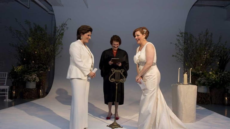 New York City Council Speaker Christine Quinn, right, exchanges vows...