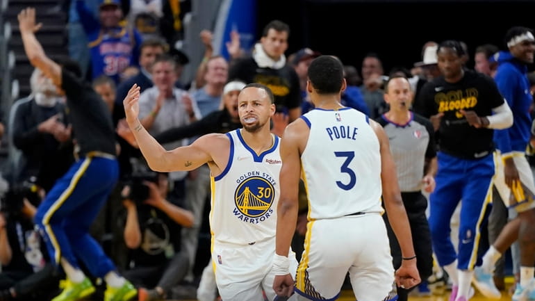 Golden State Warriors guard Stephen Curry (30) is congratulated by...