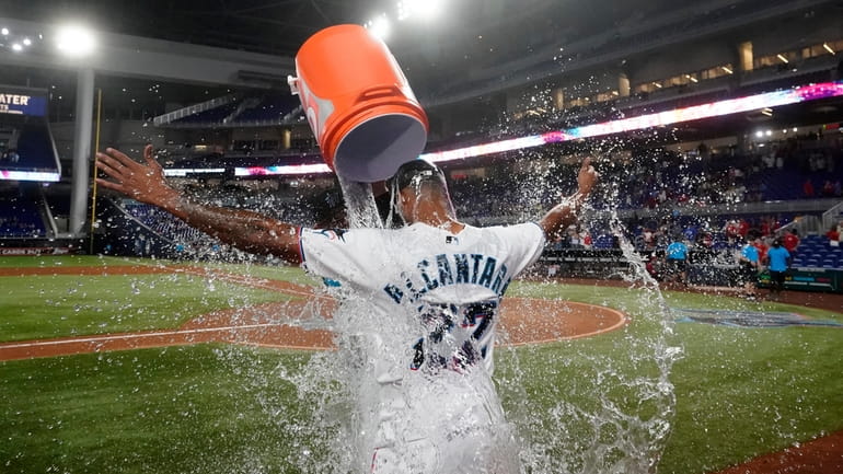 Miami Marlins starting pitcher Sandy Alcantara is doused by Pablo...