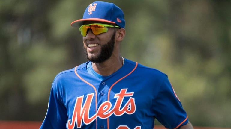 New York Mets shortstop Amed Rosario looks on during a...