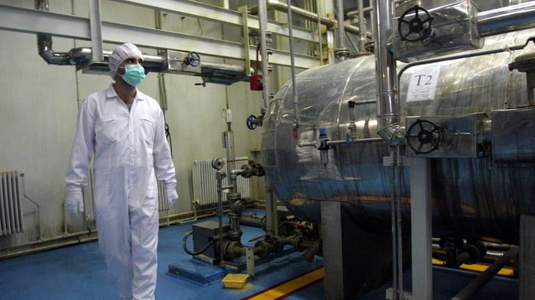 An Iranian technician walks through the Uranium Conversion Facility just...
