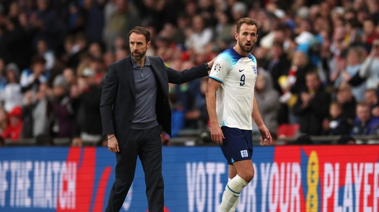 England's coach Gareth Southgate, left, salutes England's Harry Kane, as...