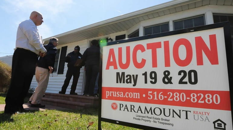 An auction sign in front of the Sandy-damaged home on...