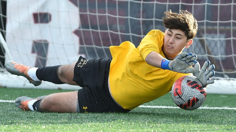 Declan Whitfield, St. Anthony's goalie, makes a save during the...