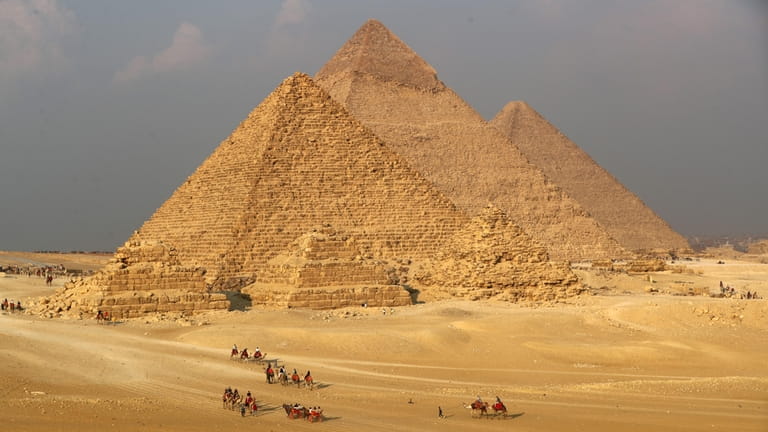 Tourists visit the Giza Pyramids scenic spot in Giza, Egypt.