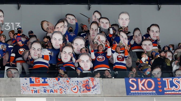 Fans of the Islanders' Adam Pelech cheer during a game...