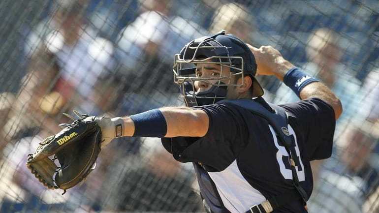 Jesus Montero #83 of the New York Yankees works on...