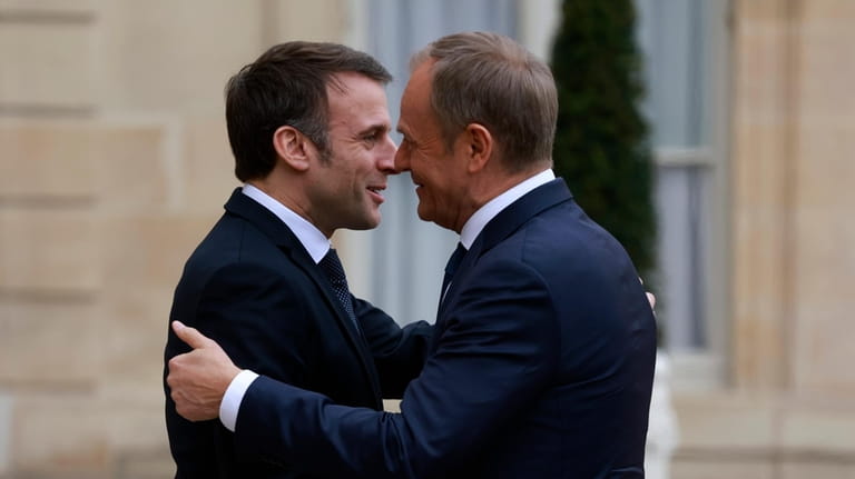 French President Emmanuel Macron, left, welcomes Poland's Prime Minister Donald...