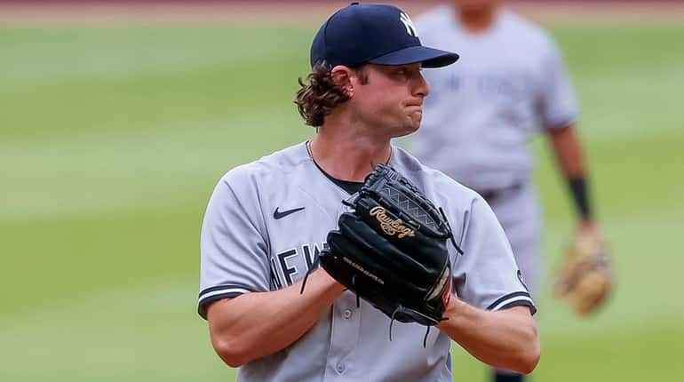 Yankees starting pitcher Gerrit Cole reacts during the second inning...