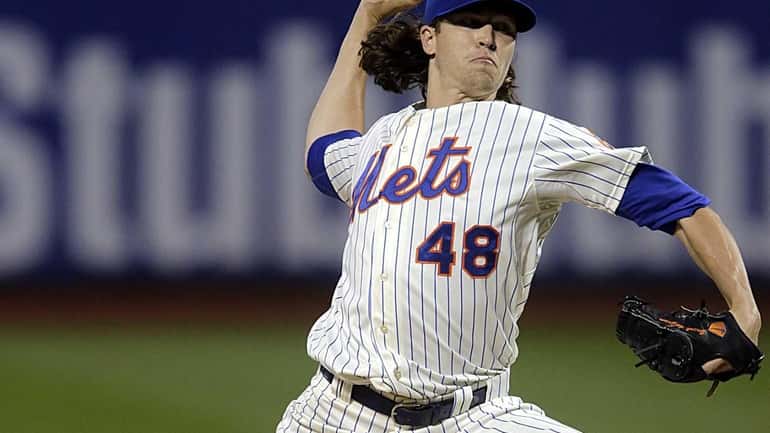 Mets starting pitcher Jacob deGrom delivers in the first inning...
