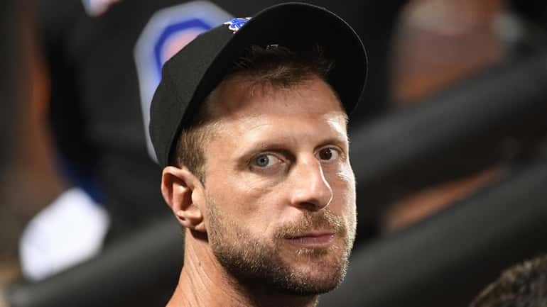 New York Mets pitcher Max Scherzer in the dugout against...