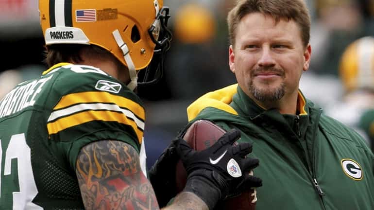 Green Bay Packers tight end coach Ben McAdoo talks with...