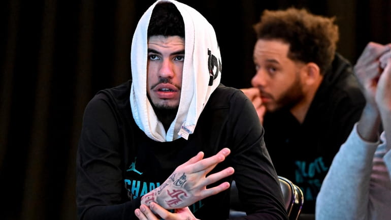 Charlotte Hornets guard LaMelo Ball looks on during an NBA...