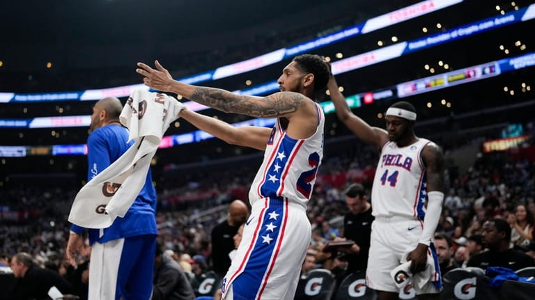 Philadelphia 76ers guard Cameron Payne, center, reacts after a 3-point...
