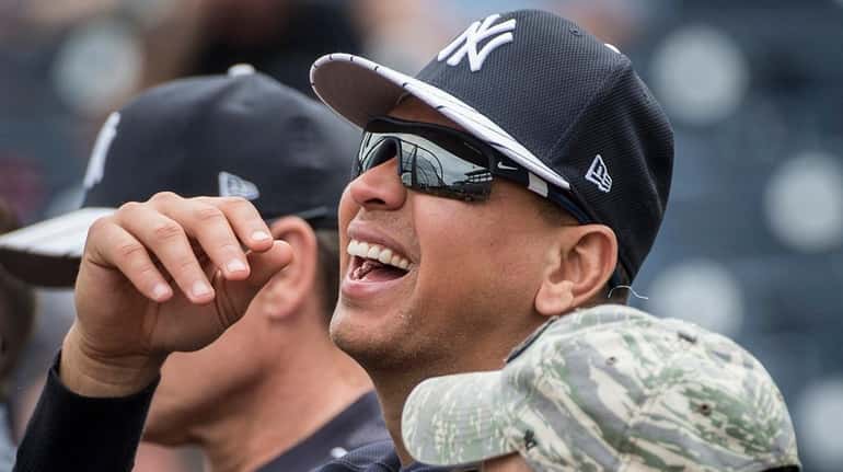 Former New York Yankees third baseman Alex Rodriguez talks with...