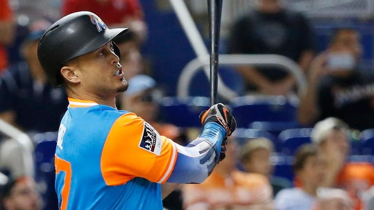 Miami Marlins' Giancarlo Stanton watches the ball after he hit...