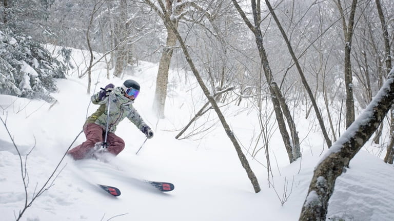 Skiers tackle the challenging slopes found at Killington Resort,  in...