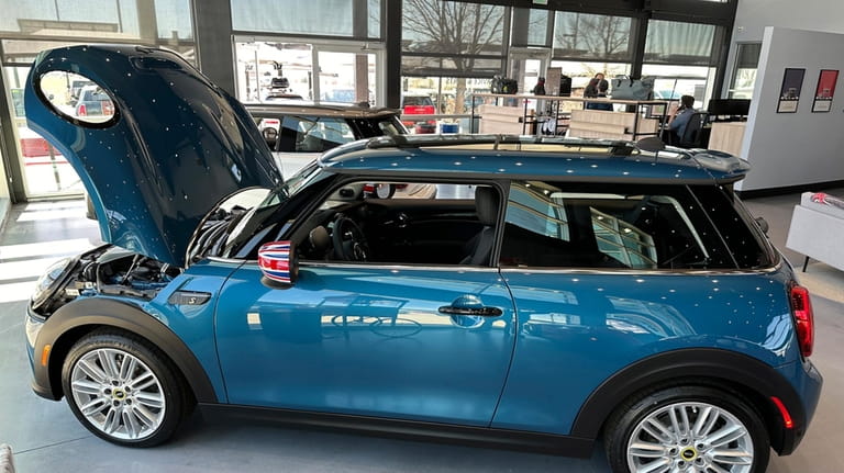 An unsold 2024 Cooper SE electric hardtop sits on the...