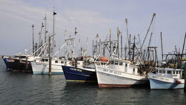 Commercial fishing vessels sit tied to the Shinnnecock commercial dock...