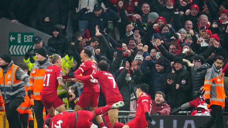 Liverpool players celebrate after Liverpool's Trent Alexander-Arnold scored his side's...