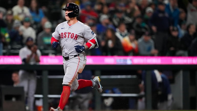 Boston Red Sox's Tyler O'Neill nears home after hitting a...