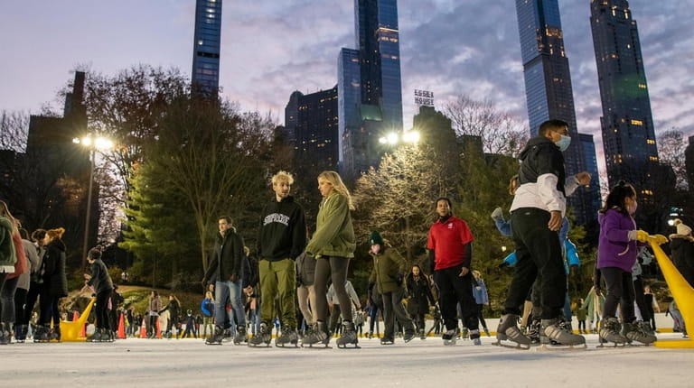 People skate on the ice at Wollman Rink in Central...