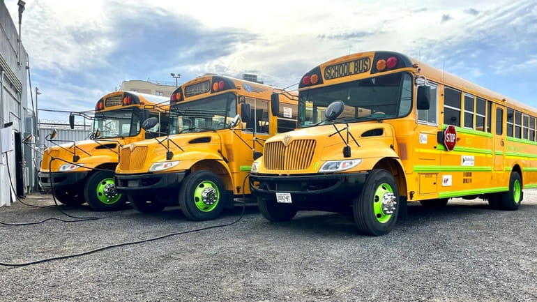 Electric school buses from Logan Bus Co. Inc. provide transportation in...