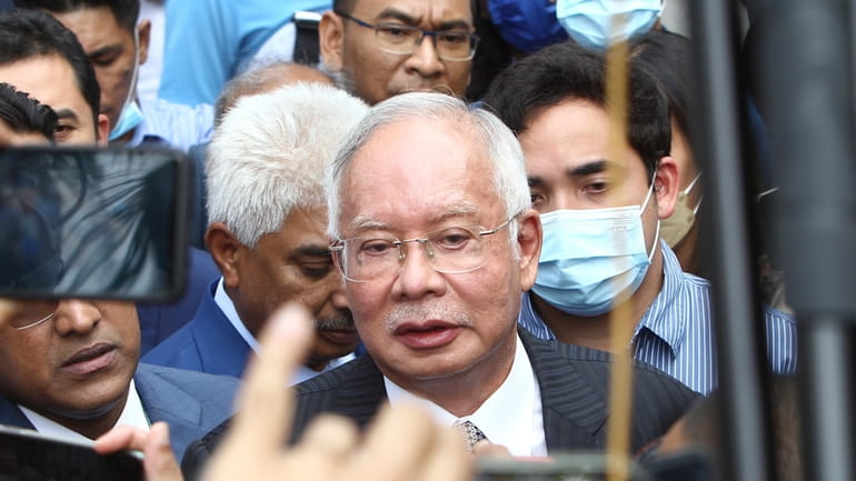 Former Malaysian Prime Minister Najib Razak, center, speaks to supporters...