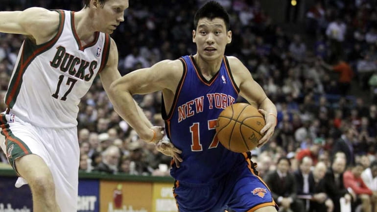 New York Knicks' Jeremy Lin, right, tries to drive past...