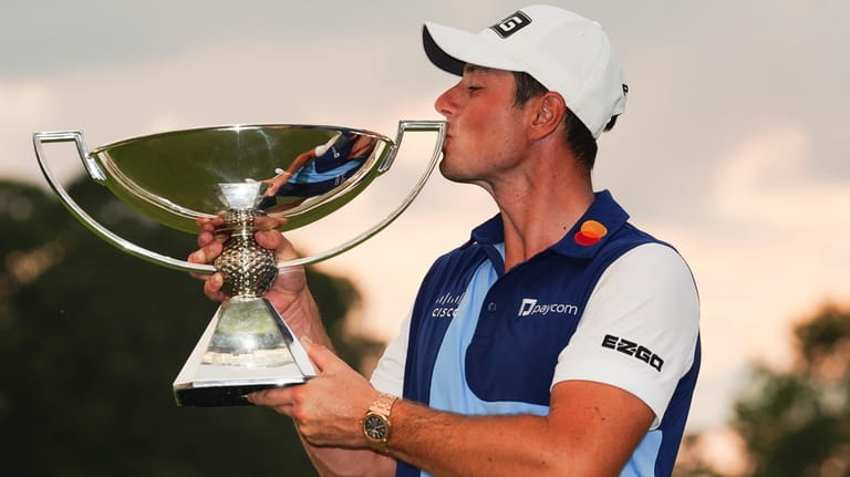 Viktor Hovland, of Norway, celebrates winning the Tour Championship golf...