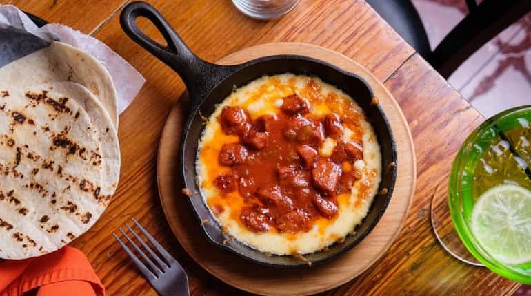 Molten queso fundido with chorizo comes with warm tortillas at...