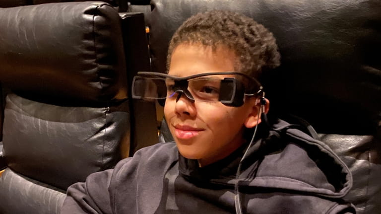 Christopher Castillo, 12, uses special closed-captioning glasses.



	 