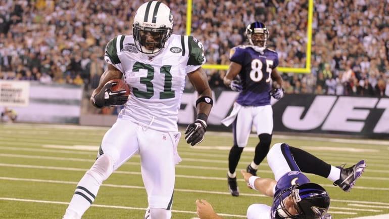 The Jets' Antonio Cromartie is forced out of bounds by...