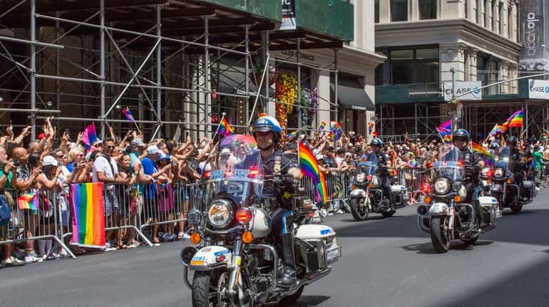 NYPD officers ride their motorcycles at New York City's annual...