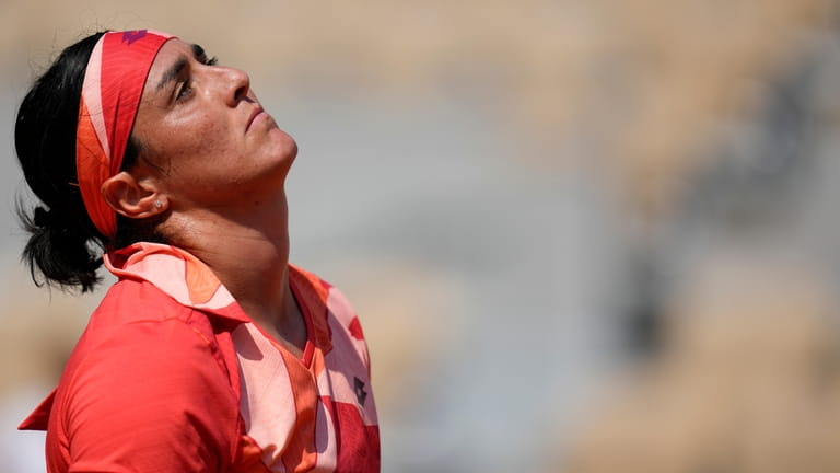 Tunisia's Ons Jabeur reacts after missing a shot against Brazil's...