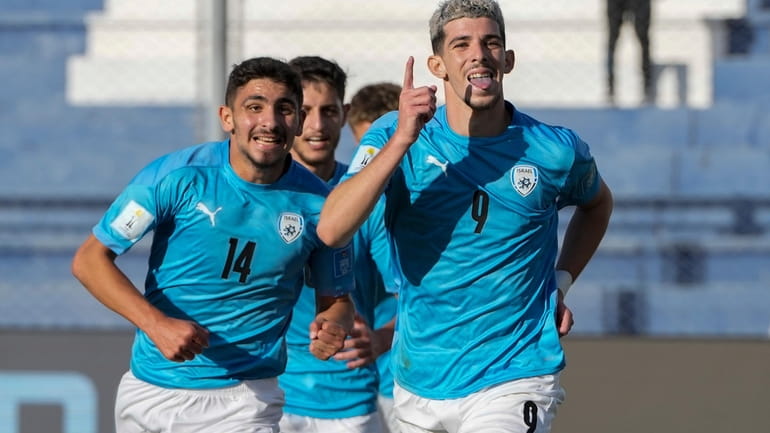 Israel's Dor Turgeman, right, celebrates with teammates after scoring his...