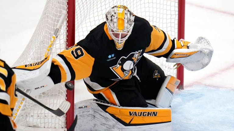 Pittsburgh Penguins goaltender Alex Nedeljkovic blocks a Carolina Hurricanes shot...