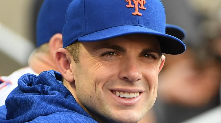 Mets third baseman David Wright looks on from the dugout against...