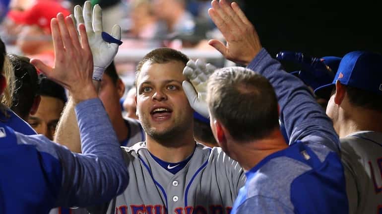 Devin Mesoraco is congratulated by teammates after he hit his...