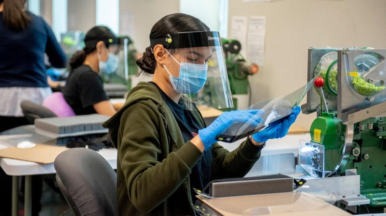 Face shields are being assembled at Farmingdale's D'Addario & Co., which...