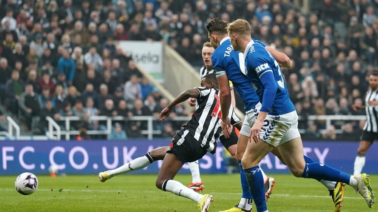 Newcastle United's Alexander Isak, centre, scores their side's first goal...