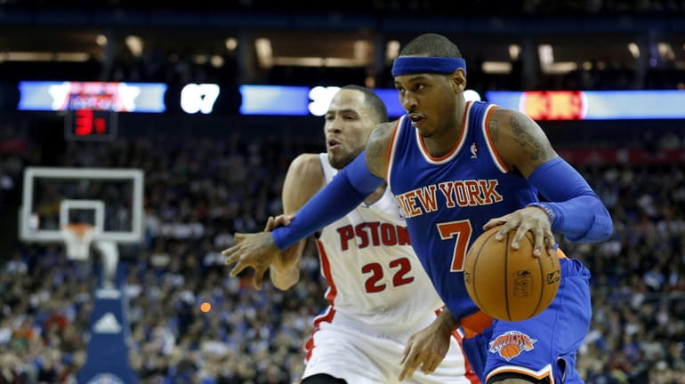 Knicks forward Carmelo Anthony, right, tries to take the ball...