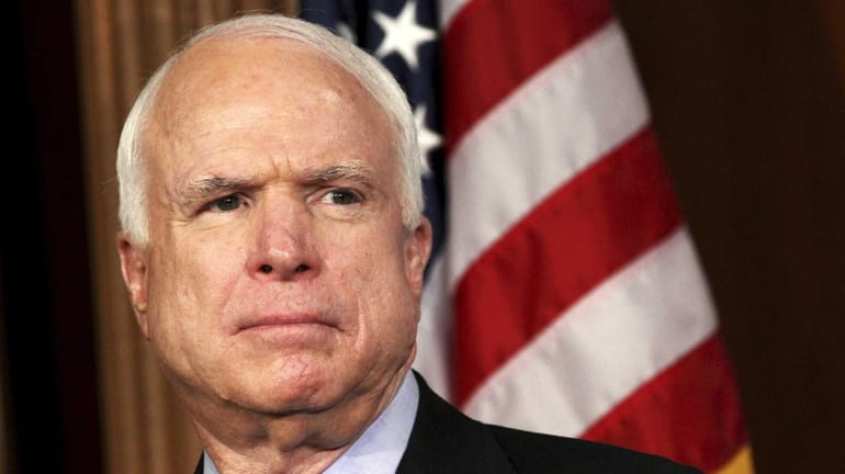 Sen. John McCain, R-Ariz. listens during a news conference on...